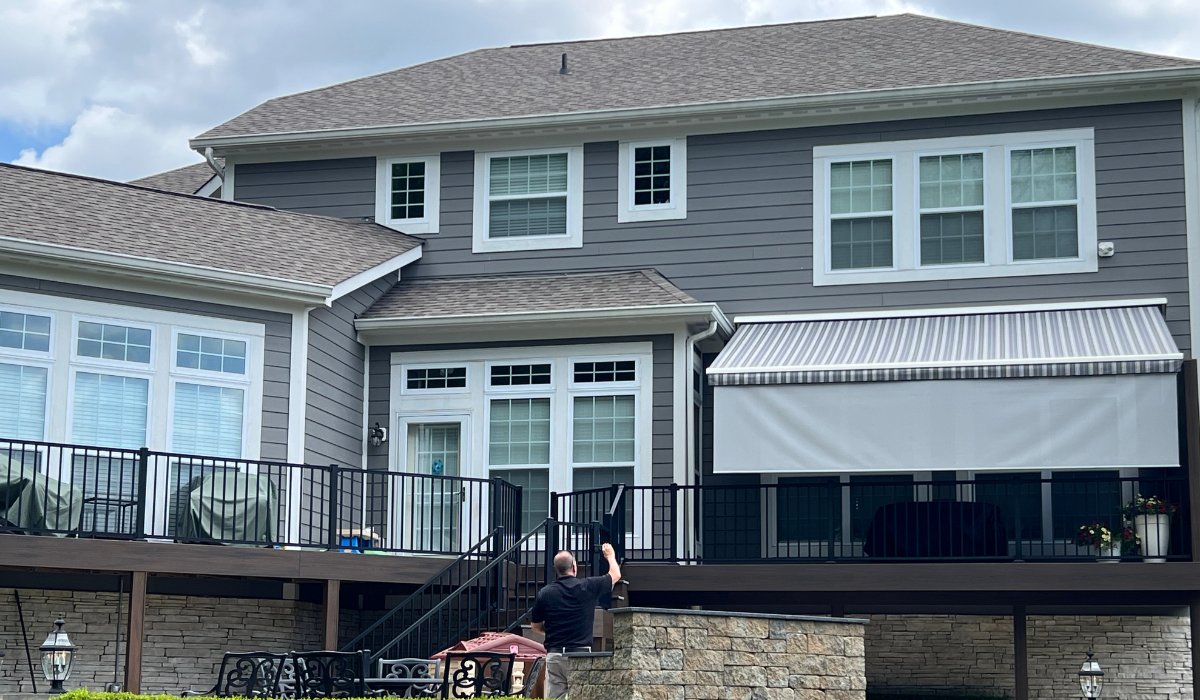 Striped commercial awnings being installed in a shop.